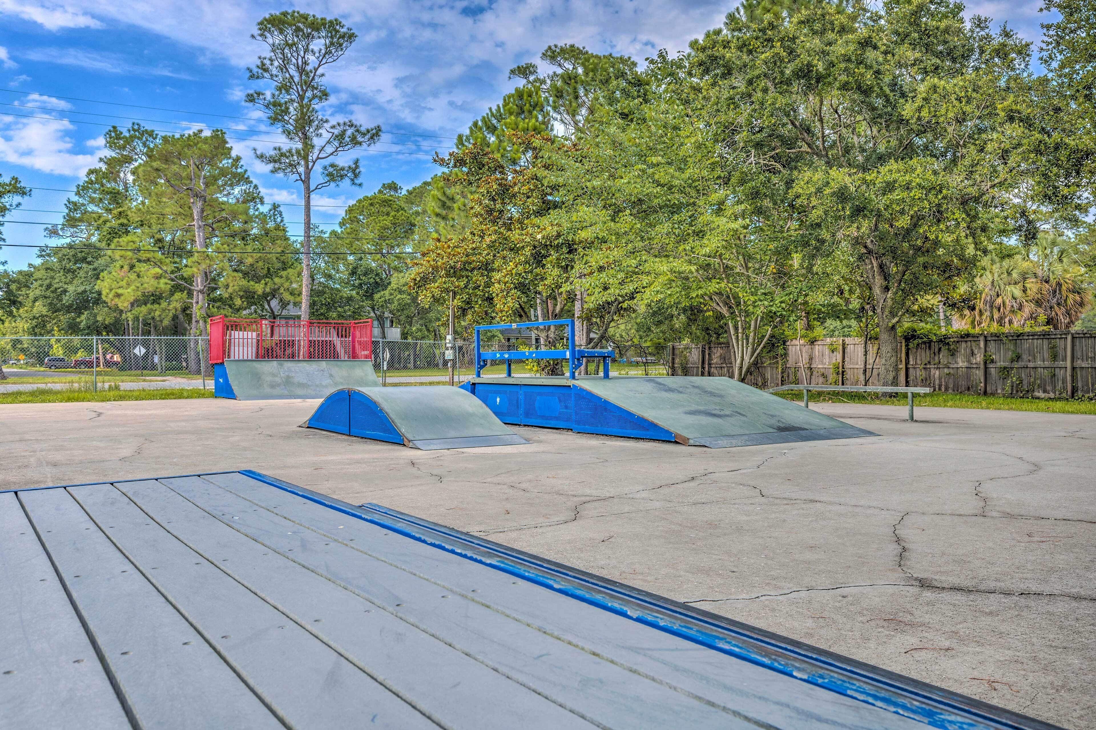 A skate park with ramps and a red structure.