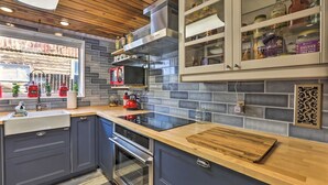 A modern kitchen with dark cabinets, a wooden countertop, a built-in oven, and a microwave. - Remodeled Lake Cabin, Stunning Mtn View, New Patio (Twin Lakes)