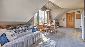 A cozy loft-style living space with a high ceiling, a dining area, and a kitchen. - Fraser Couple's Hideaway w/ Indian Peaks View (Fraser)