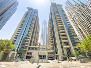 A modern building with a central entrance, multiple floors, and a glass facade. - Silkhaus Boulevard Central, Downtown Dubai (Dubai)