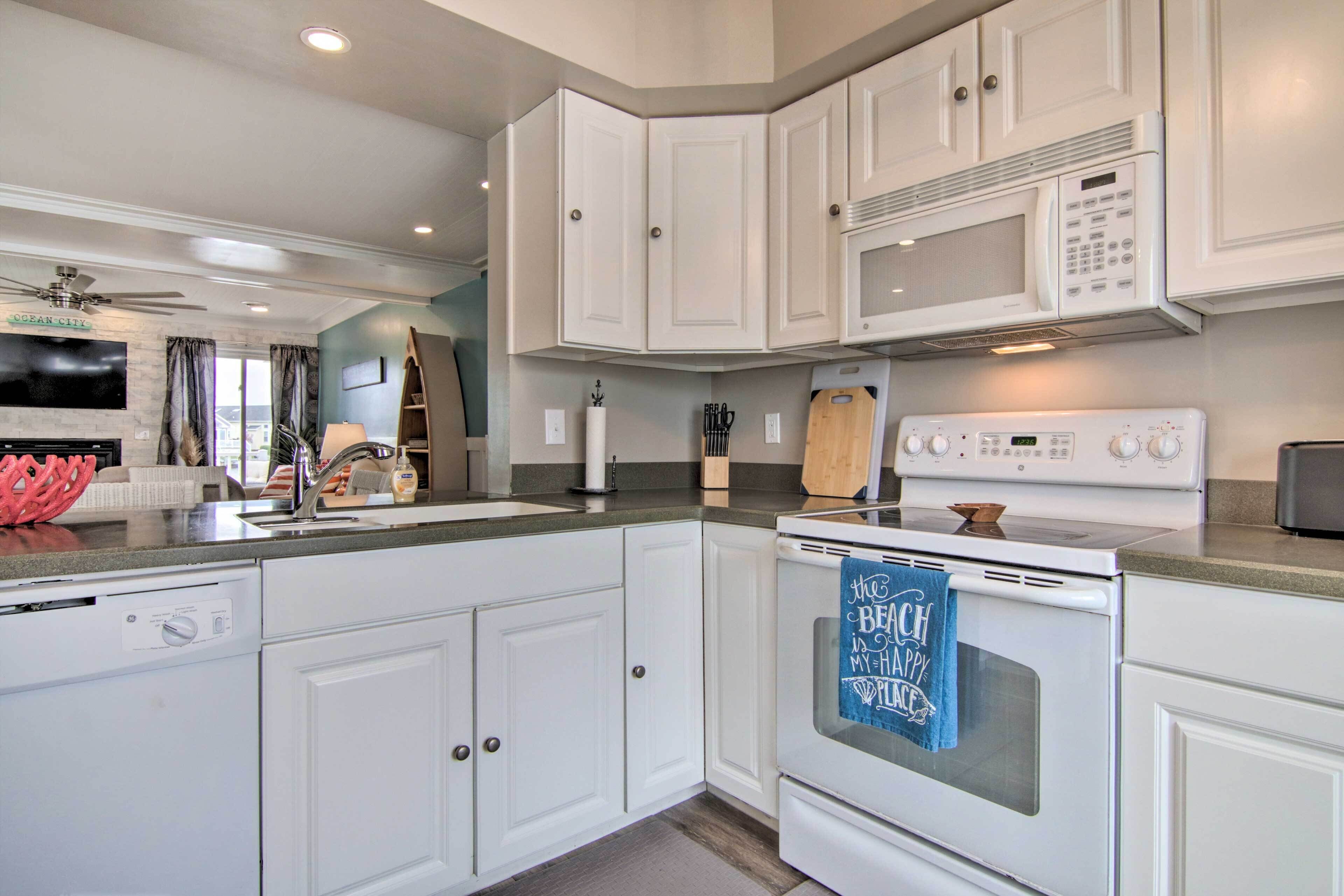 A modern kitchen with white cabinets, a microwave, an oven, and a dishwasher.