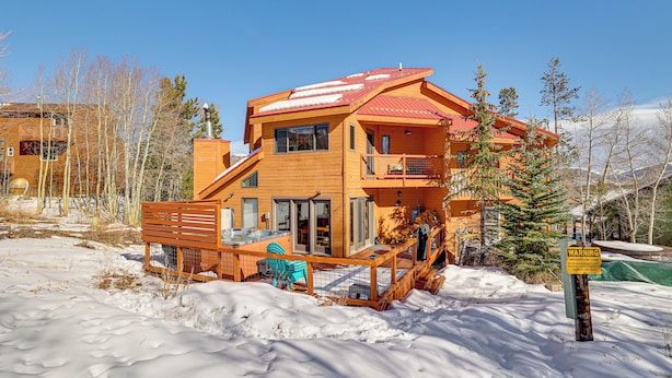 A two-story wooden house with a red roof, a deck, and a warning sign. - 10 Mi to Keystone Resort: Cabin w/ Private Hot Tub (Silverthorne)