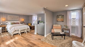 A bedroom with a bed, bedside tables, a desk, and a chair. - Secluded Lothian Farmhouse on 45 Acres w/ Fire Pit (Lothian)