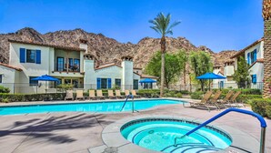 A pool area with lounge chairs, a hot tub, and a mountain backdrop. - 243460: 3BR Desert Retreat w/ Views + Pool Access (La Quinta)