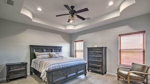 A bedroom with a bed, nightstands, a dresser, a chair, and a ceiling fan. - South Padre Paradise w/ Saltwater Pool Near Golf! (Port Isabel)