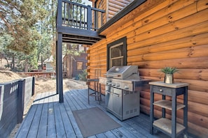 A wooden deck with a grill and a small table with a plant. - Big Bear Lake Cabin w/ Hot Tub < 1 Mi to Skiing! (Big Bear Lake)