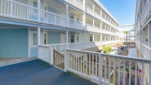 Un hôtel à plusieurs étages, doté de balcons et d’une cour intérieure.