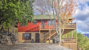 A two-story building with a red exterior and a wooden balcony. - Smoky Mountain Retreat w/ Hot Tub, Arcade Games (Sevierville)