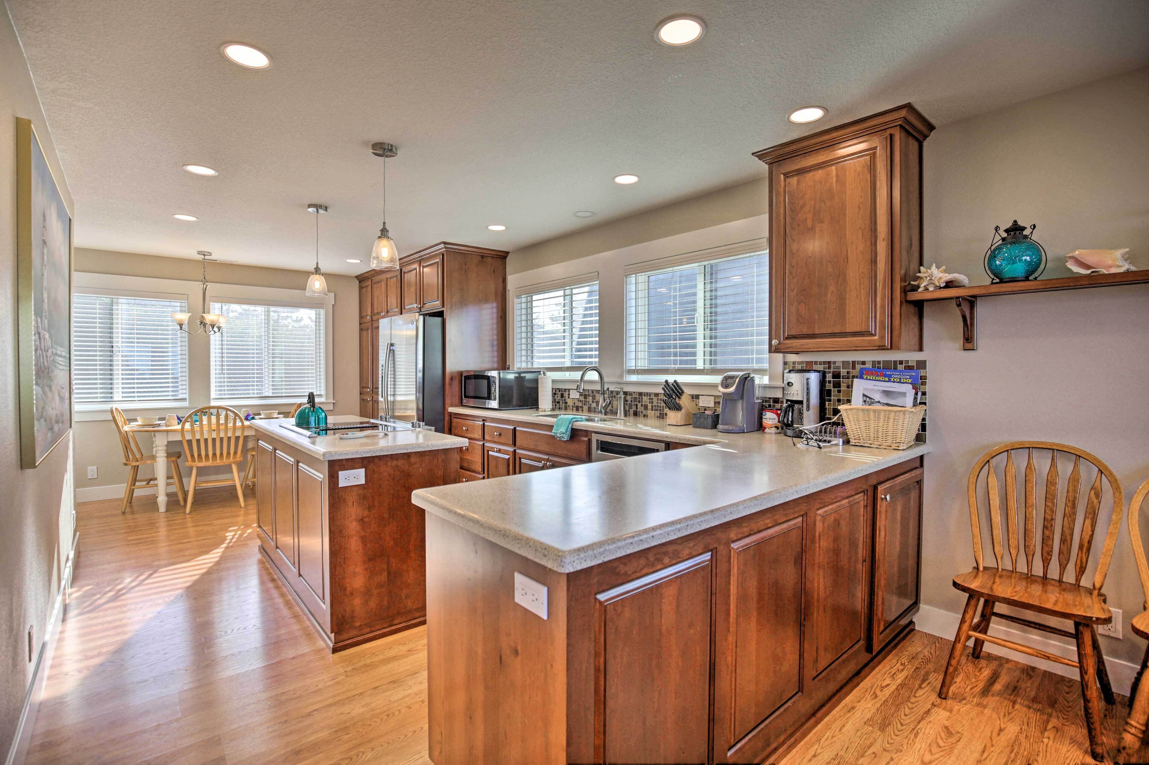 A modern kitchen with wooden cabinets, a central island, and a dining area with a table and chairs.