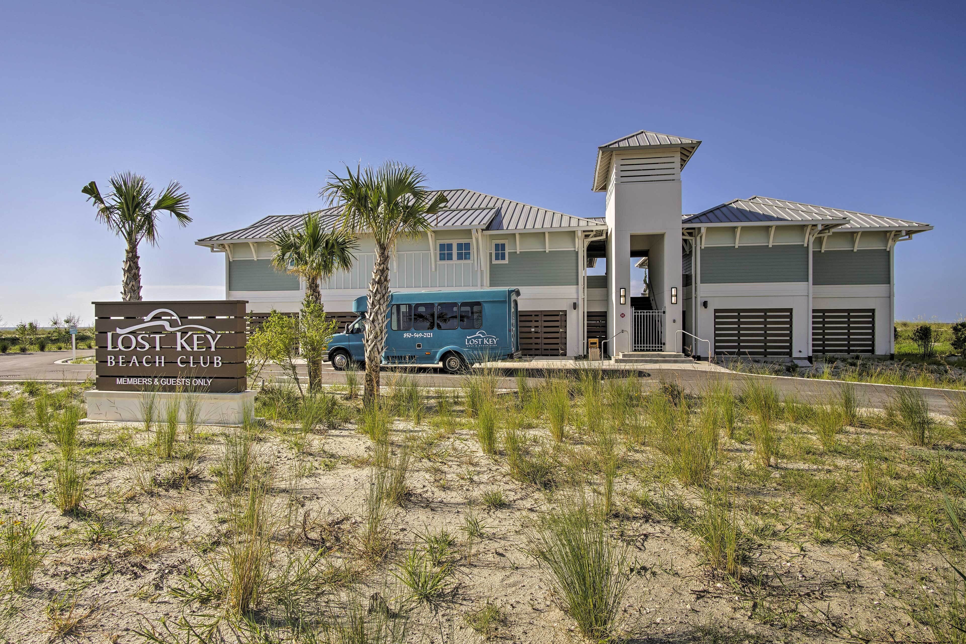 A building with a sign reading "Lost Key Beach Club" and a blue truck parked in front.