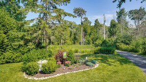 Un jardin aménagé avec une grande variété de plantes et un chemin dallé.