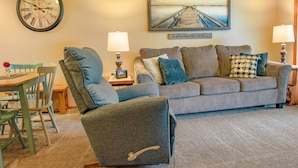 A living room with a couch, two armchairs, a dining table with chairs, a clock, and a painting on the wall. - Cozy Branson Getaway ~ 2 Mi to Silver Dollar City! (Branson West)