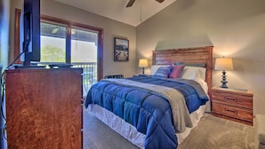 A bedroom with a bed, a wooden dresser, a ceiling fan, and a window with blinds. - Cozy Branson Getaway ~ 2 Mi to Silver Dollar City! (Branson West)