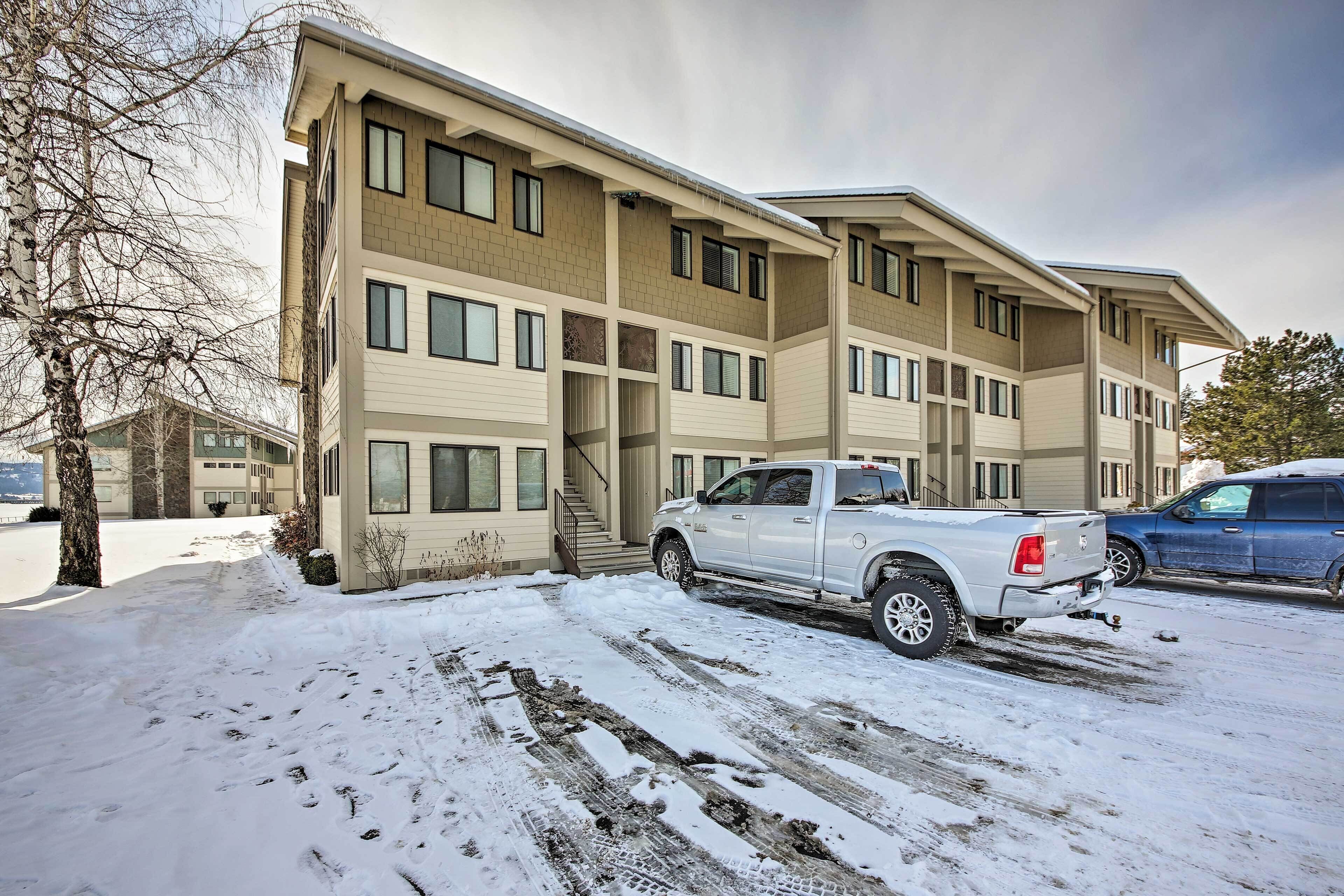 A multi-story building with a parking area.