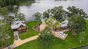 A residential property with a house, a dock, and a boat. - Shoreline Home w/ Boat Dock & Fire Pit in Shelby! (Shelby)