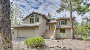A two-story house with a garage, a front porch, and a small front yard with a tree and shrubs. - Sunriver Getaway w/ Sharc Waterpark Passes! (Bend)