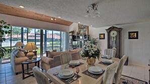 A spacious dining area with a large table set for six, surrounded by comfortable seating.