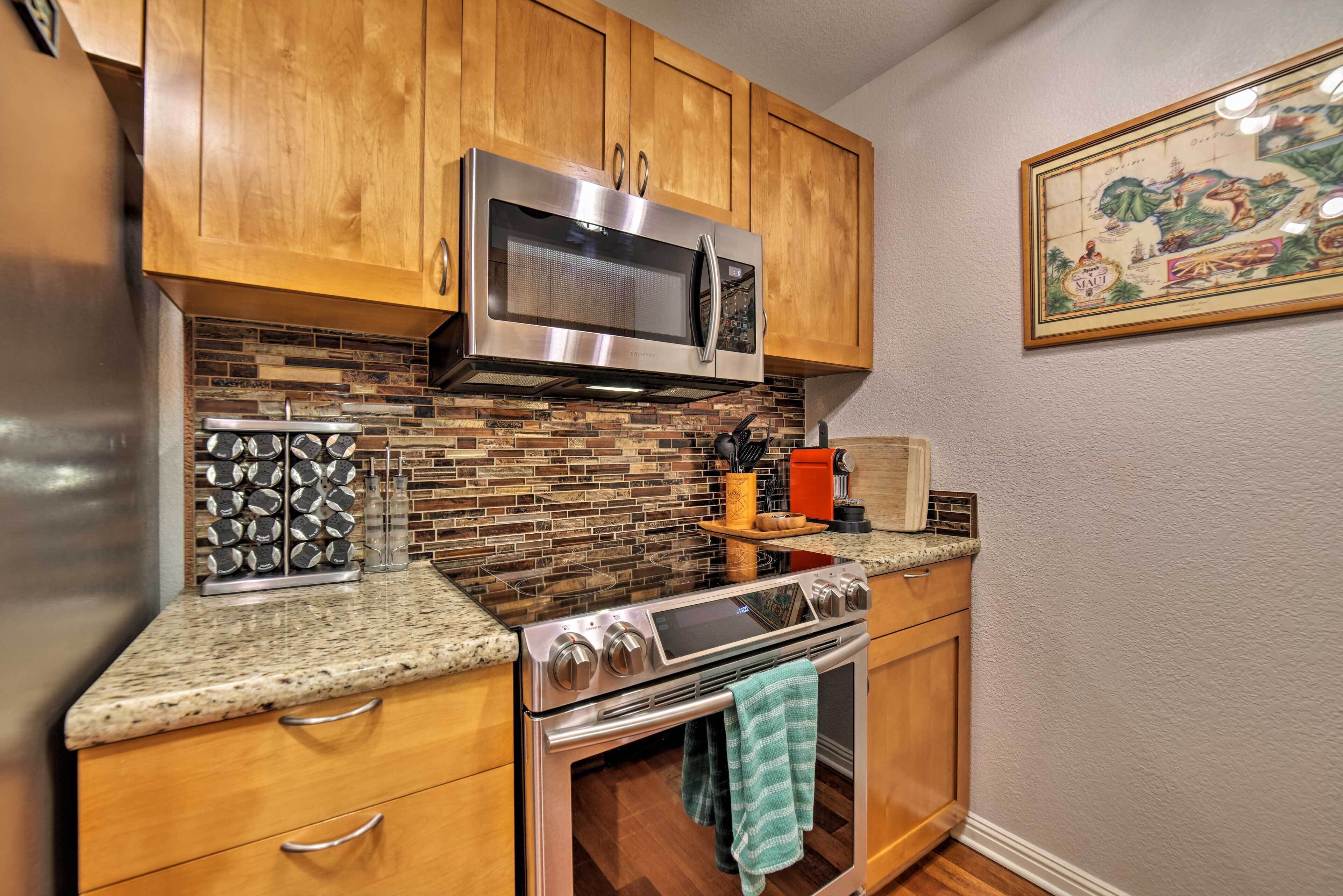 A kitchen with wooden cabinets, a stainless steel microwave, a stove, and a tiled backsplash.