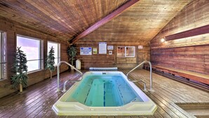 A wooden cabin with a hot tub, wooden floors, and large windows. - Slopeside Condo With Hot Tub + Game Room Access! (Brian Head)