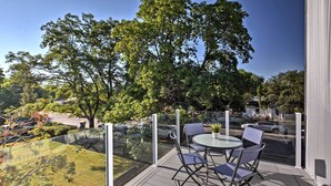 A balcony with a glass railing, a round table, and two chairs. - Missoula Getaway w/ Balcony, 2 Mi to Downtown! (Missoula)