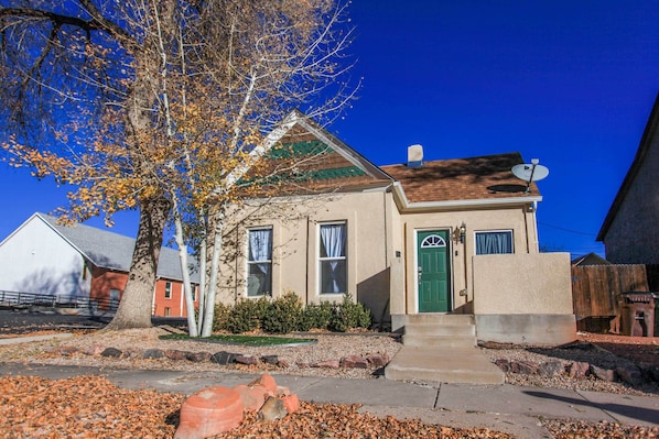 A two-story house with a green door and a satellite dish. - Downtown Home w/ Grill: 5 Mi to Garden of the Gods (Colorado Springs)