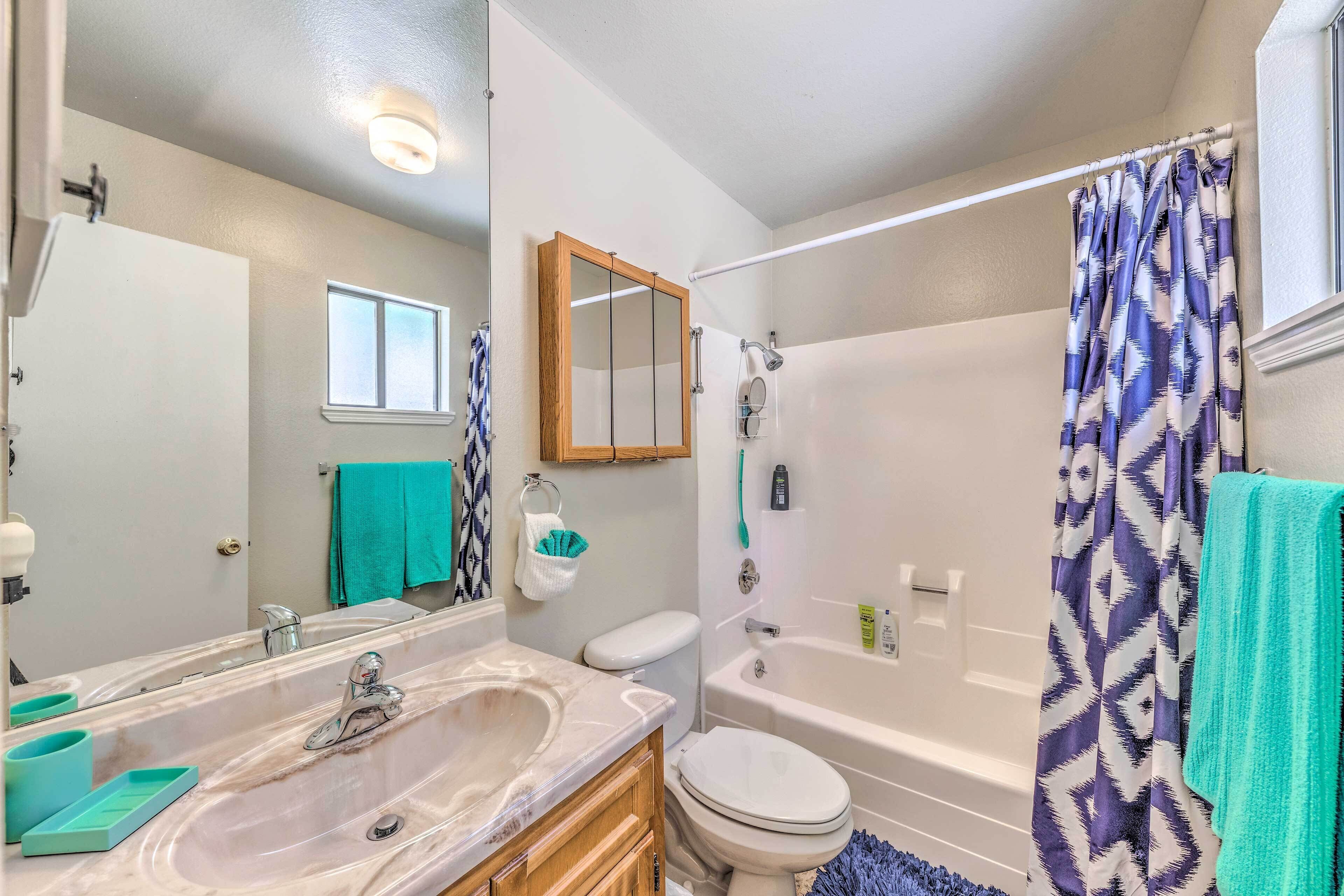 A bathroom with a large sink, toilet, and bathtub.