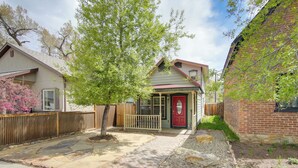 A residential property with a paved driveway, a wooden fence, and a small garden area. - Buena Vista 'shambala' Sanctuary Near Main St! (Buena Vista)