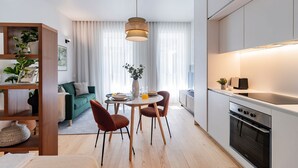 Una cocina moderna con comedor, sofá y estantería.