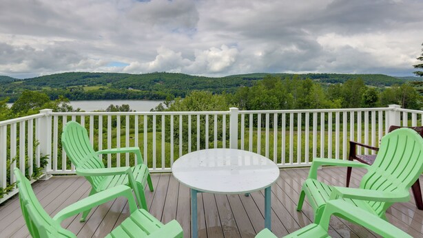 A wooden deck with a round table and four green chairs, overlooking a lake and green hills. - Private Retreat w/ Deck: 1 Mi From Cowanesque Lake (Lawrenceville)