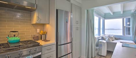 A modern kitchen with stainless steel appliances, a gas stove, and a built-in oven.