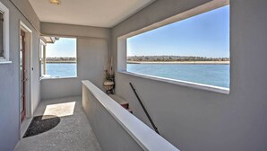 A balcony with a view of the sea and a cityscape. - Chic Bay View Condo < 10 Miles to Dtwn San Diego! (San Diego)