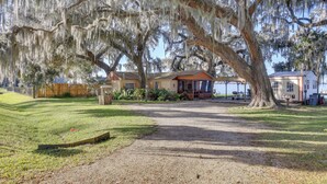 A house with a large porch and a covered outdoor seating area. - Riverfront St Augustine Retreat, Near Boat Launch! (St. Augustine)