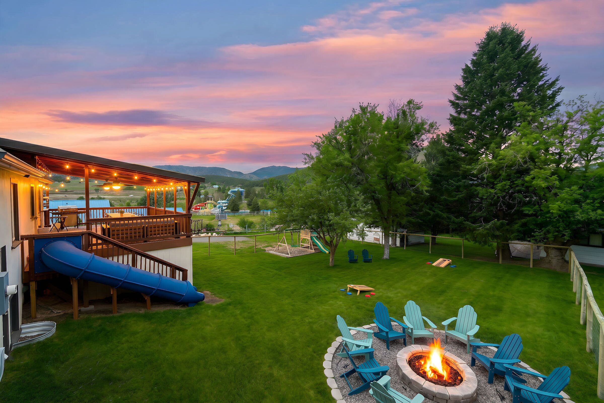 The large, fenced backyard has plenty of room, a tube slide, fire pit, and kid's play set. Have fun!