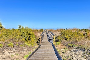 A wooden boardwalk leading through a natural landscape. - Harbor Island Beach Retreat - Steps to Ocean! (Harbor Island)
