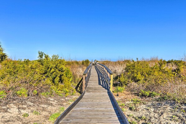 A wooden boardwalk leading through a natural landscape. - Harbor Island Beach Retreat - Steps to Ocean! (Harbor Island)