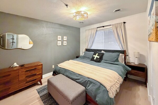 A bedroom with a bed, nightstand, dresser, and a mirror. - Walk to Main St: Frisco Condo w/ Community Pool! (Frisco)