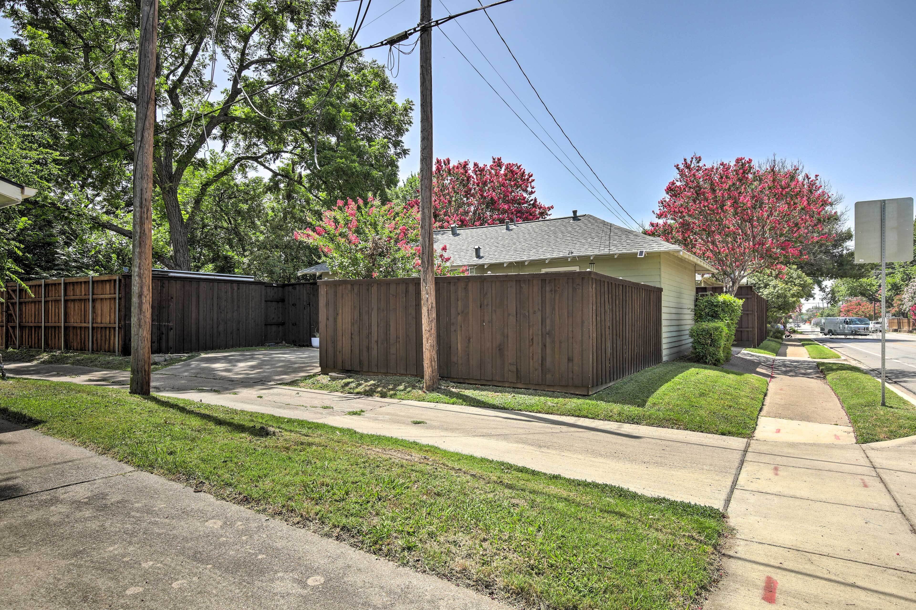 A residential property with a fenced backyard, a single-story house, and a well-maintained lawn.