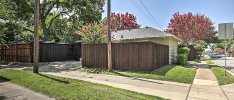 A residential property with a fenced backyard, a single-story house, and a well-maintained lawn.