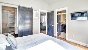 A bedroom with a large bed, a wardrobe, and a television on the wall. - Alma Retreat w/ Mtn Views ~ 17 Mi to Breck! (Alma)