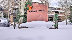 A snow-covered sign with "Village Point" written on it, surrounded by trees and buildings. - Ski-in/ski-out Condo w/ Hot Tub on Copper Mountain (Copper Mountain)