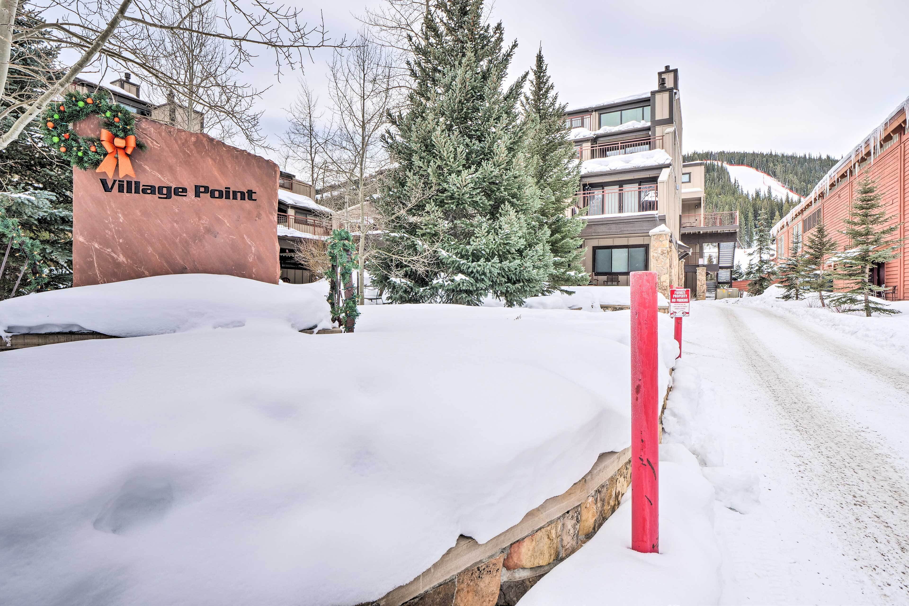A snow-covered street with a sign reading "Village Point."