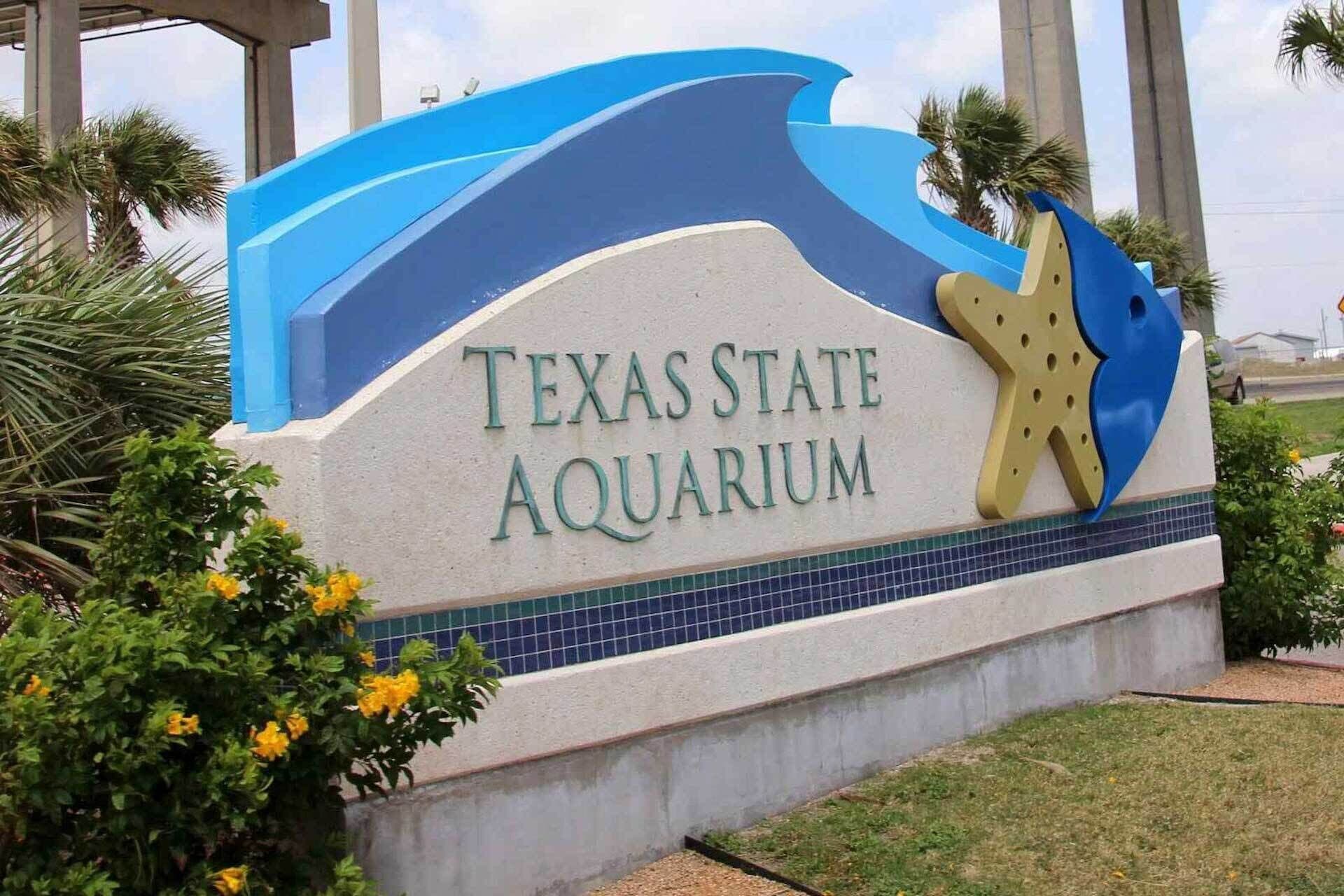A sign for Texas State Aquarium with a starfish design.