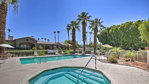 A swimming pool with steps, surrounded by palm trees and a fence. - Beautiful Gated Country Club, Prime Location (Palm Desert)