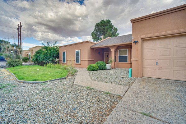 A residential house with a front yard, driveway, and garage. - Convenient Las Cruces Home w/ Patio & Grill! (Las Cruces)