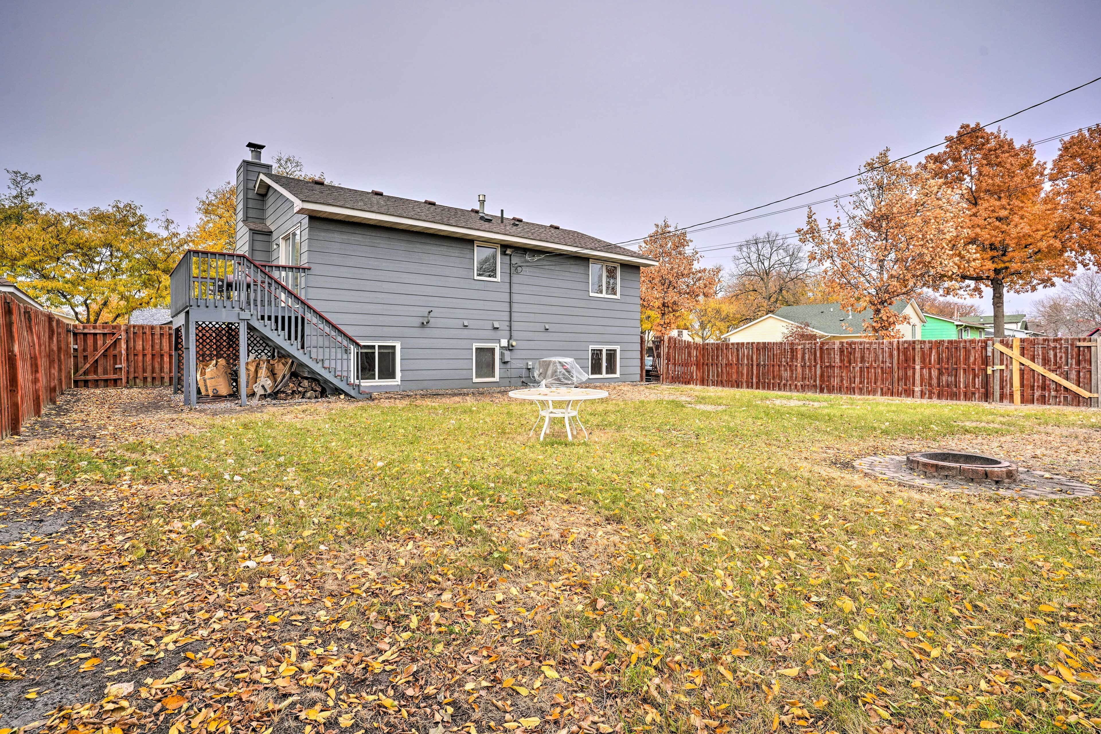A two-story house with a covered patio and a small backyard.