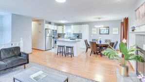 A modern apartment with a kitchen, dining area, and living room.