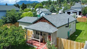 A single-story house with a porch, a garage, and a fenced yard.