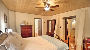 A bedroom with a bed, wooden ceiling, and a ceiling fan. There is a dresser and a mirror in the room. - Charming Couples Casita, Walk to Old Mesilla Plaza (Mesilla)