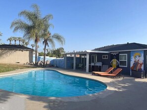 Relax by the pool surrounded by lush palm trees and enjoy the serene atmosphere.