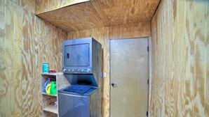 A compact room with a built-in stove, a small refrigerator, and a wooden door. - Woodsy Mountain Cabin: 2 Mi to Angel Fire Resort! (Angel Fire)